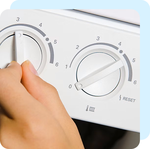 a mans hand on a knob of a heating boiler
